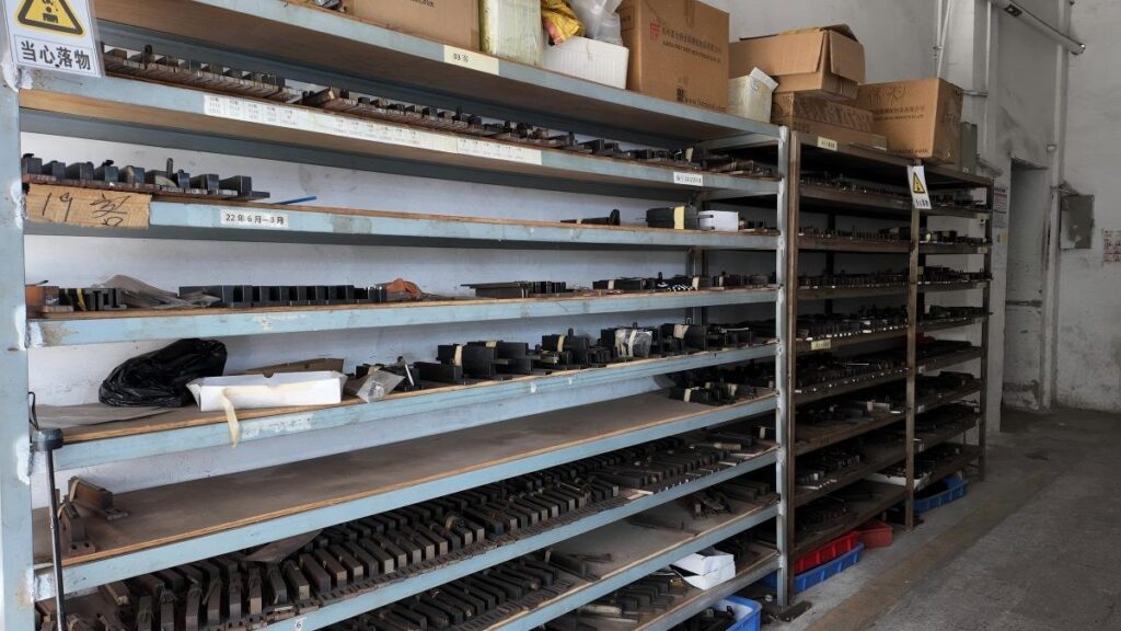 Exclusive Mold Ownership: What It Means and Why It Matters for Your Brand Steel eyewear molds stored on labeled racks in a climate-controlled facility — what exclusive mold ownership means for OEM eyewear brands